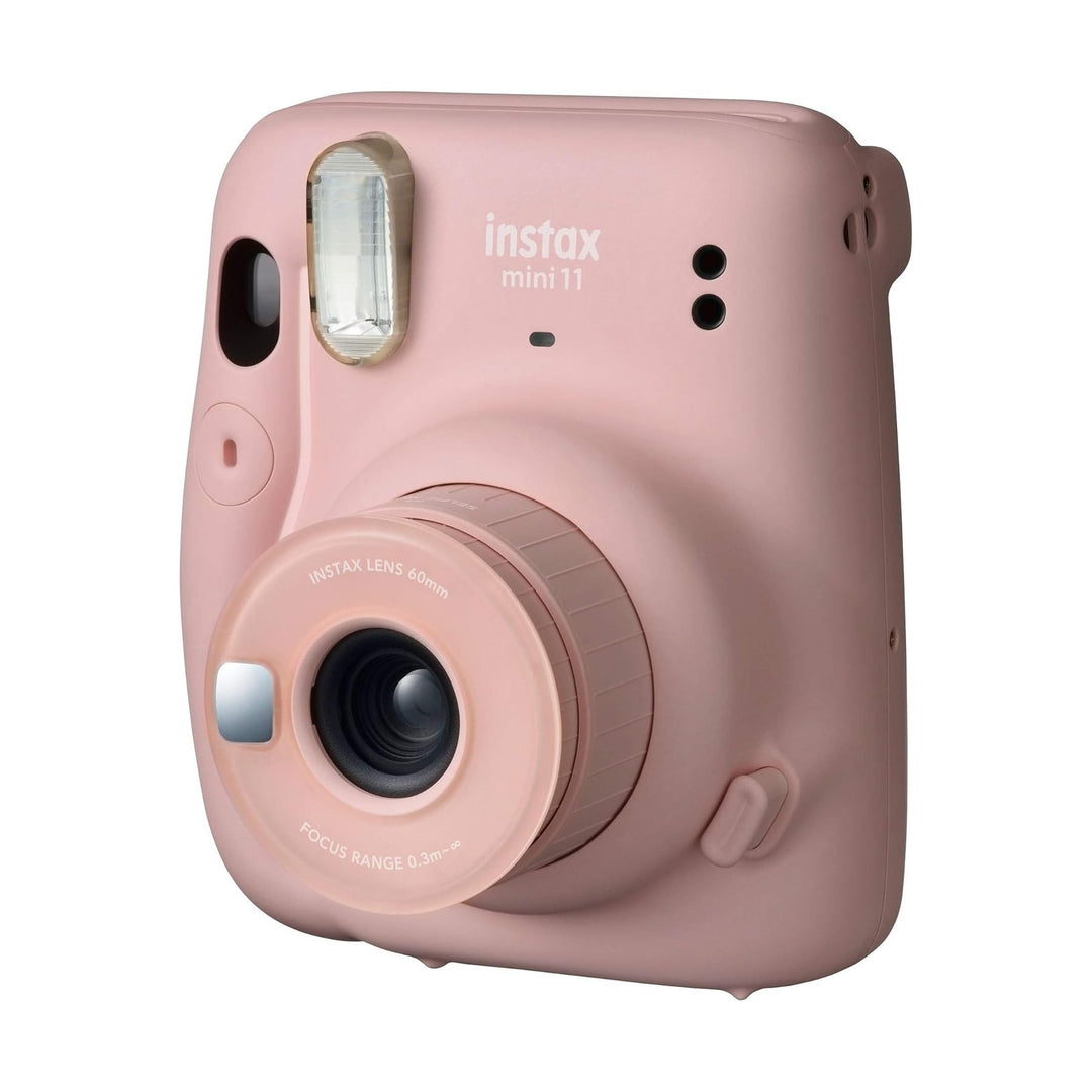Fujifilm Instax Mini 11 blush pink front angle showing gold flash frame and lens details from ClubCamera.com
