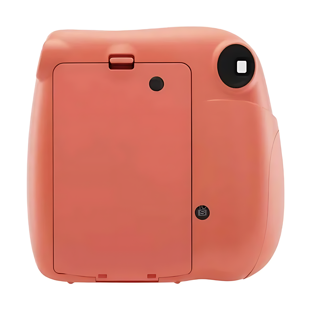 Back view of coral Fujifilm Instax Mini 7+ instant camera showing battery compartment and eject button at ClubCamera.com