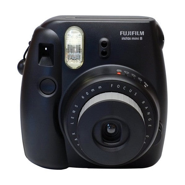 Close-up of Fujifilm Instax Mini 8 lens assembly and focus ring on matte black camera from ClubCamera.com