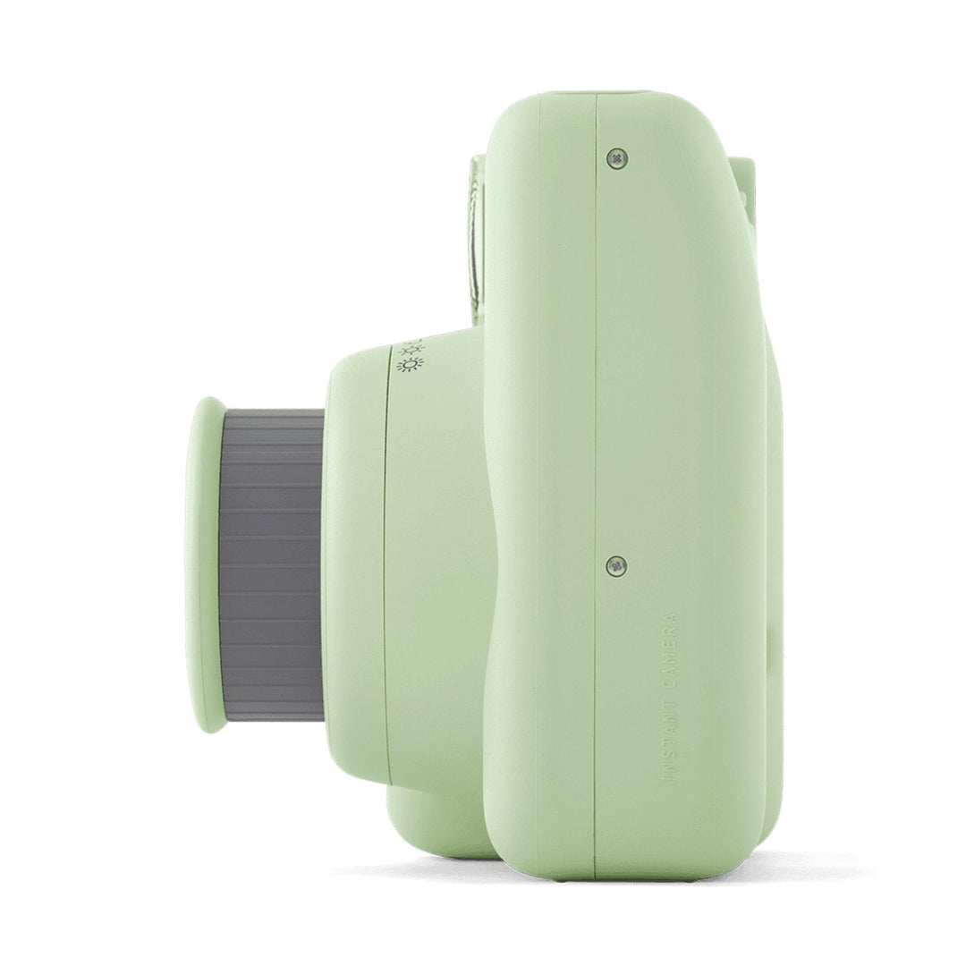 Fujifilm INSTAX Mini SE instant camera in matte light green side profile with textured gray lens barrel from ClubCamera.com