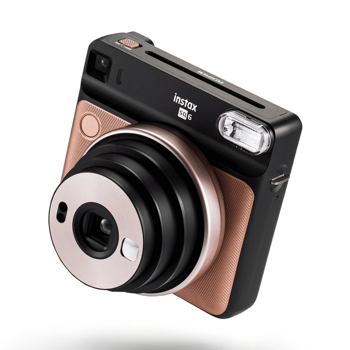 Fujifilm INSTAX Square SQ6 Blush Gold instant camera at ClubCamera.com with textured rose-gold side panels and brushed metallic lens ring