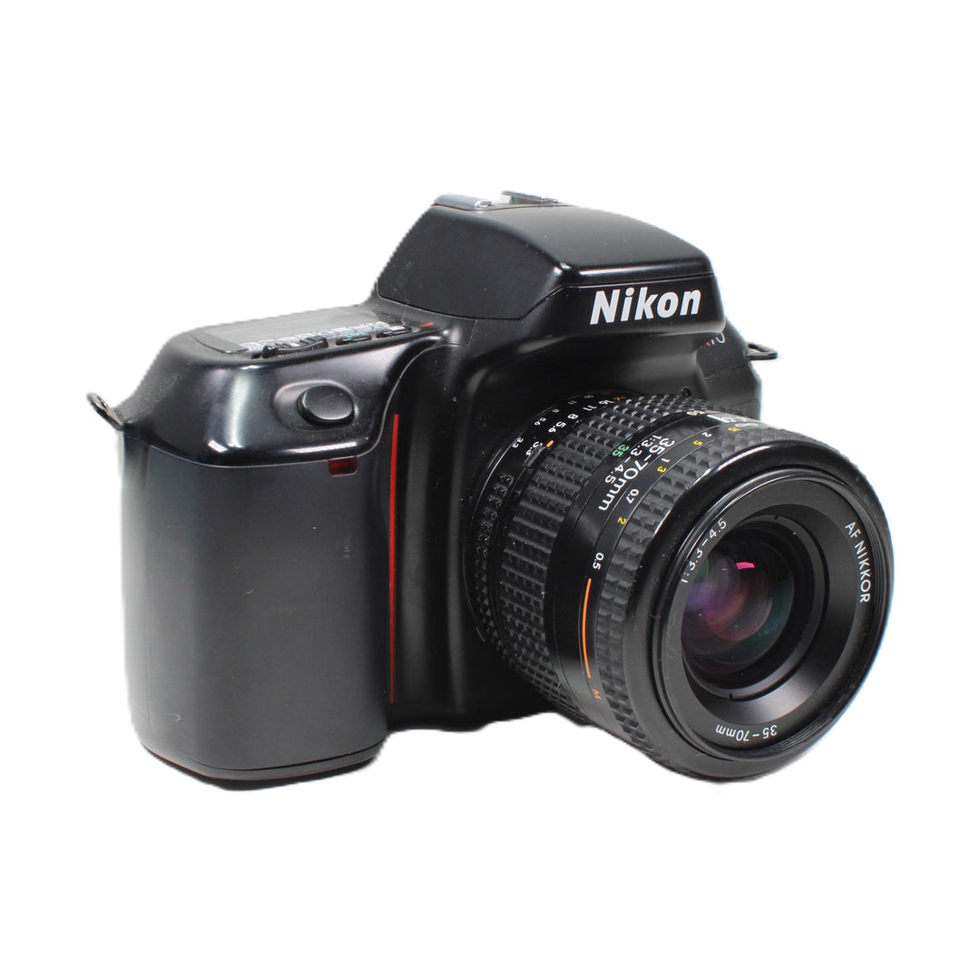 Black Nikon N70 SLR camera with red accent stripe and AF Nikkor 35-70mm lens at ClubCamera.com highlighting ribbed rubberized focus ring