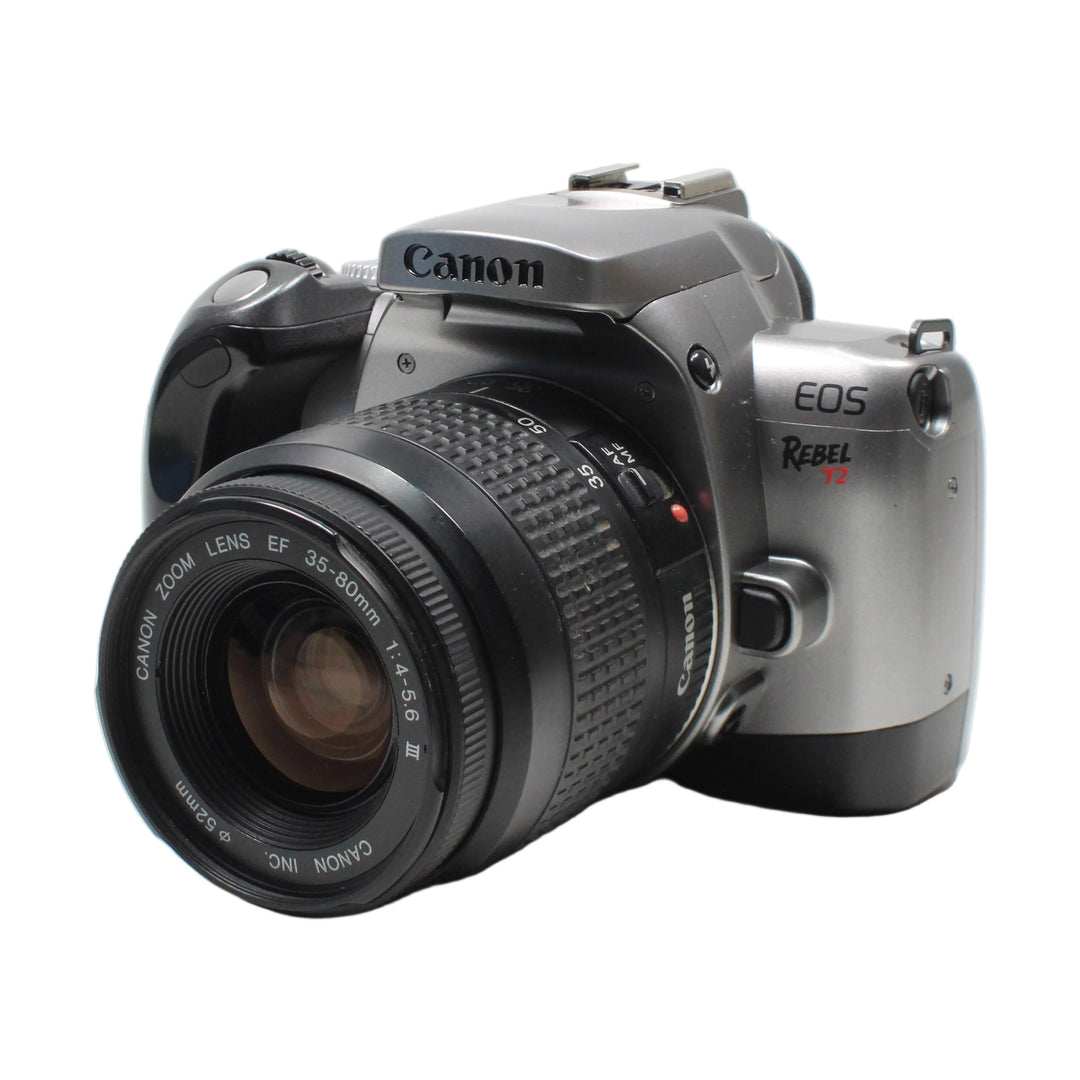 Canon EOS Rebel T2 front angle showing Canon logo and EF 35-80mm lens specs from ClubCamera.com