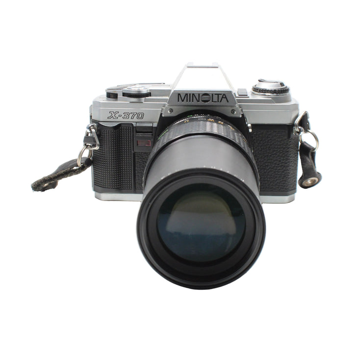 Minolta X-370 SLR film camera with MD zoom lens and leather strap at ClubCamera.com