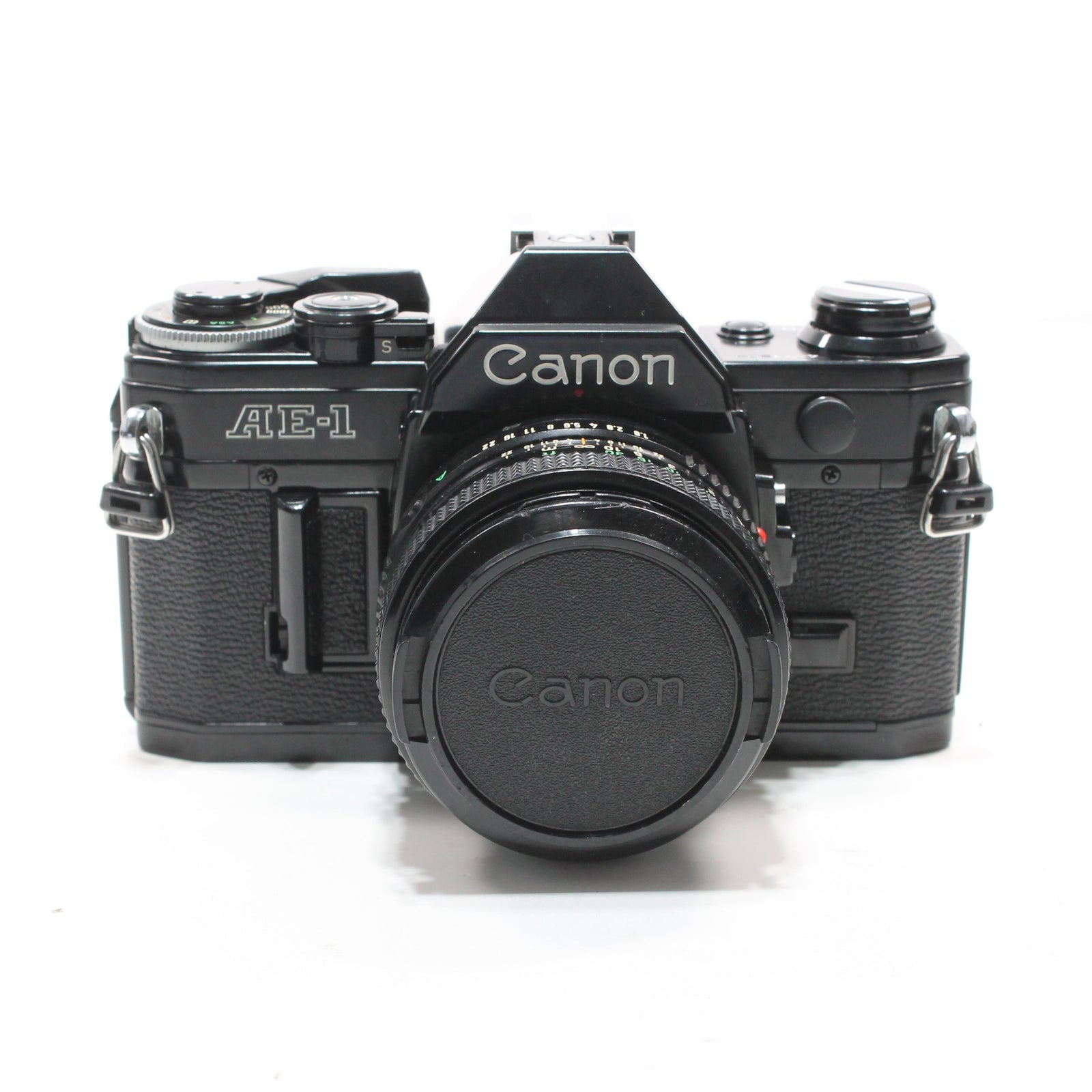 Canon AE-1 Black 35mm SLR film camera front view with lens cap on and silver logo details at ClubCamera.com