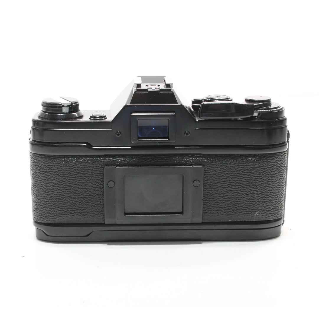 Canon AE-1 Black SLR film camera rear view with textured rubber grip and matte metal top plate at ClubCamera.com