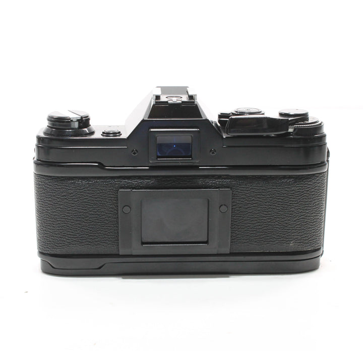 Canon AE-1 Black SLR film camera rear view with textured rubber grip and matte metal top plate at ClubCamera.com