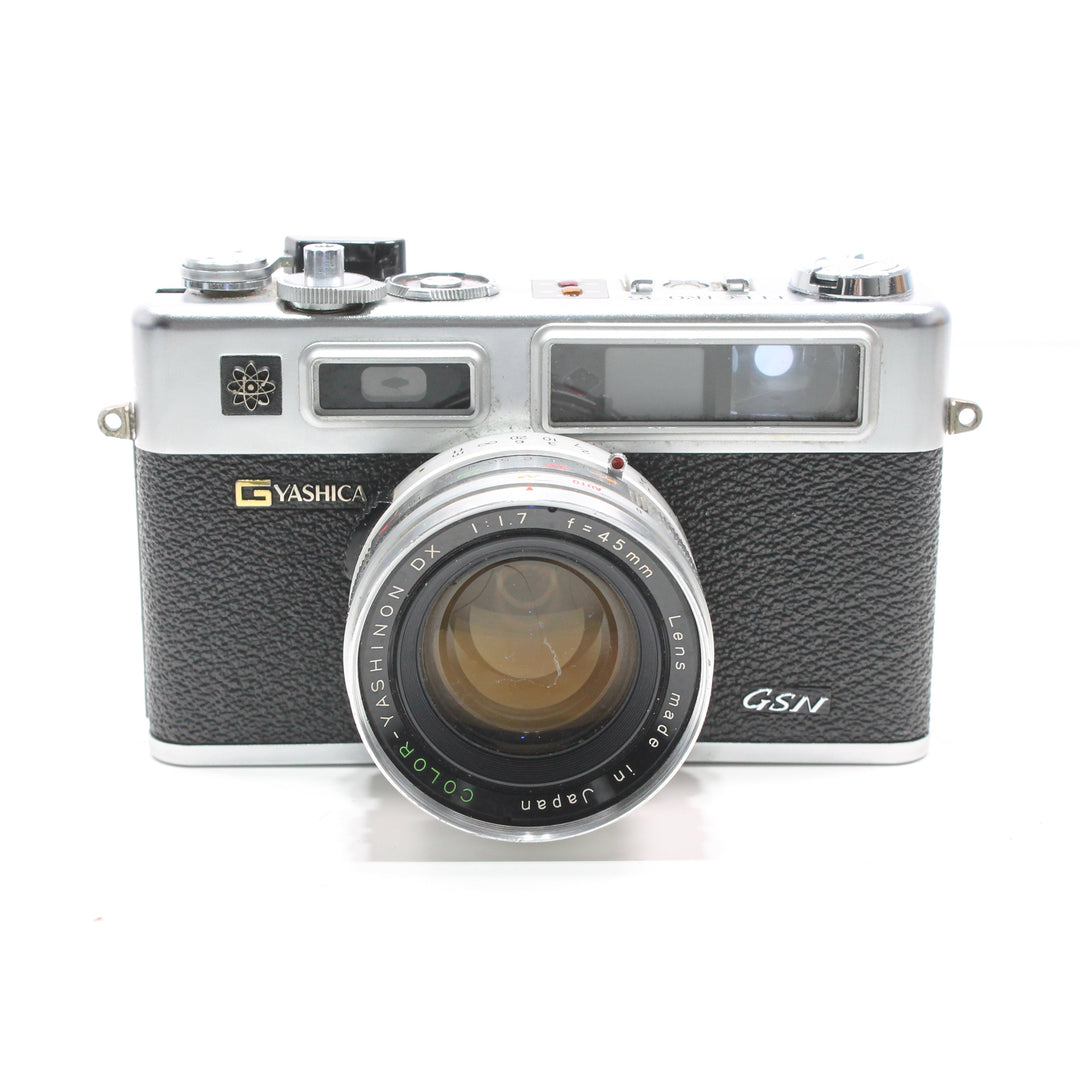 ClubCamera.com angled shot of Yashica Electro 35 GSN with gold logo, atomic emblem, and textured leatherette grip