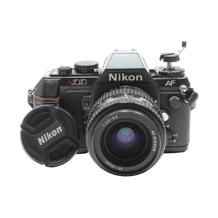 Nikon N2020 35mm SLR film camera kit with AF lens at ClubCamera.com showing top controls and red grip trim