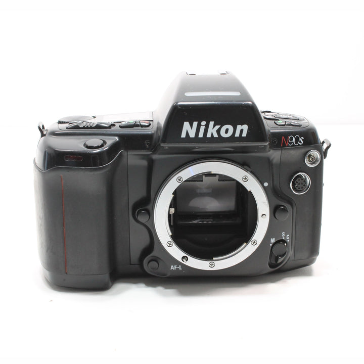 Front view of black Nikon N90s SLR film camera body with silver lens mount and red accent stripe from ClubCamera