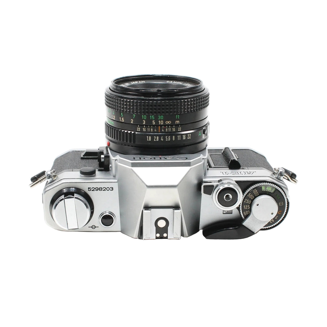 Top-down ClubCamera.com Canon AE-1 silver film camera with shutter speed dials and FD lens
