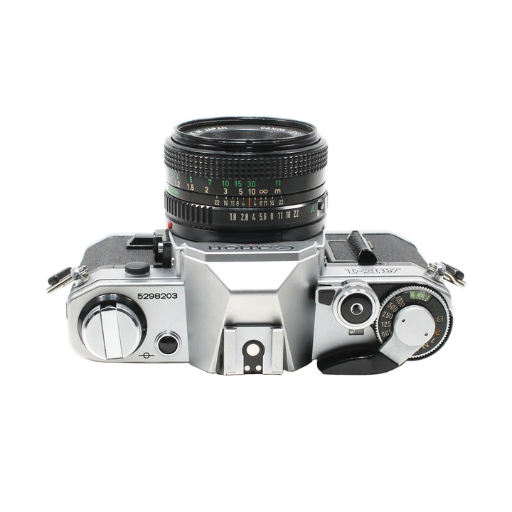 Top-down ClubCamera.com Canon AE-1 silver film camera with shutter speed dials and FD lens