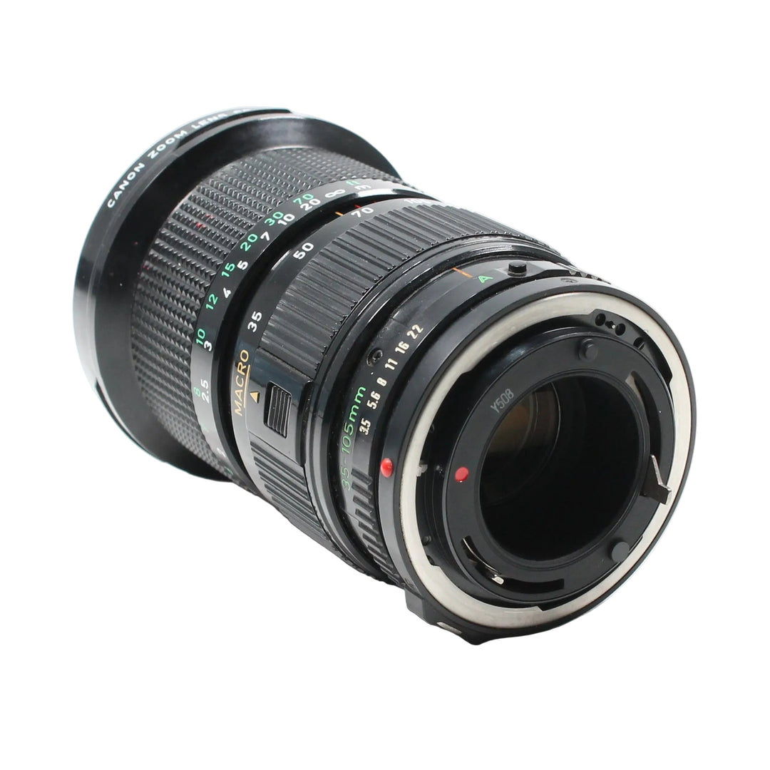 Canon FD 35-105mm f/3.5 lens three-quarter angle highlighting textured grip rings and FD bayonet mount details