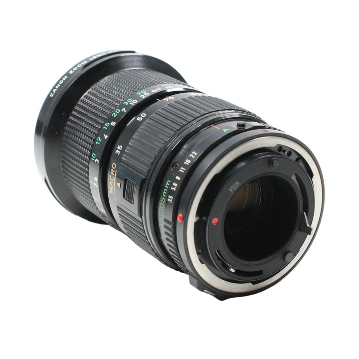 Canon FD 35-105mm f/3.5 lens three-quarter angle highlighting textured grip rings and FD bayonet mount details