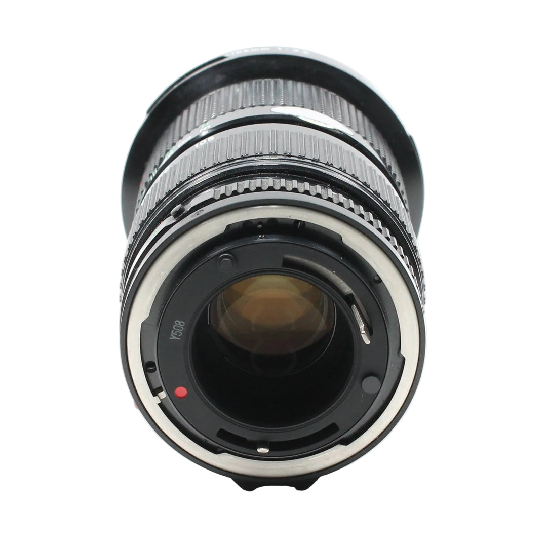 Rear view of Canon FD mount interface on 35-105mm f/3.5 lens featuring red alignment dot and silver inner ring