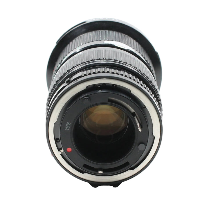 Rear view of Canon FD mount interface on 35-105mm f/3.5 lens featuring red alignment dot and silver inner ring