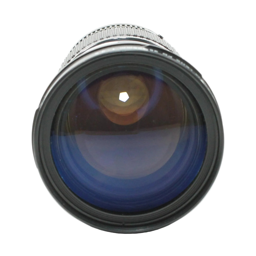 Close-up of Canon FD 35-105mm f/3.5 front element with deep blue multi-coated optics and hexagonal aperture