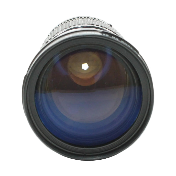 Close-up of Canon FD 35-105mm f/3.5 front element with deep blue multi-coated optics and hexagonal aperture
