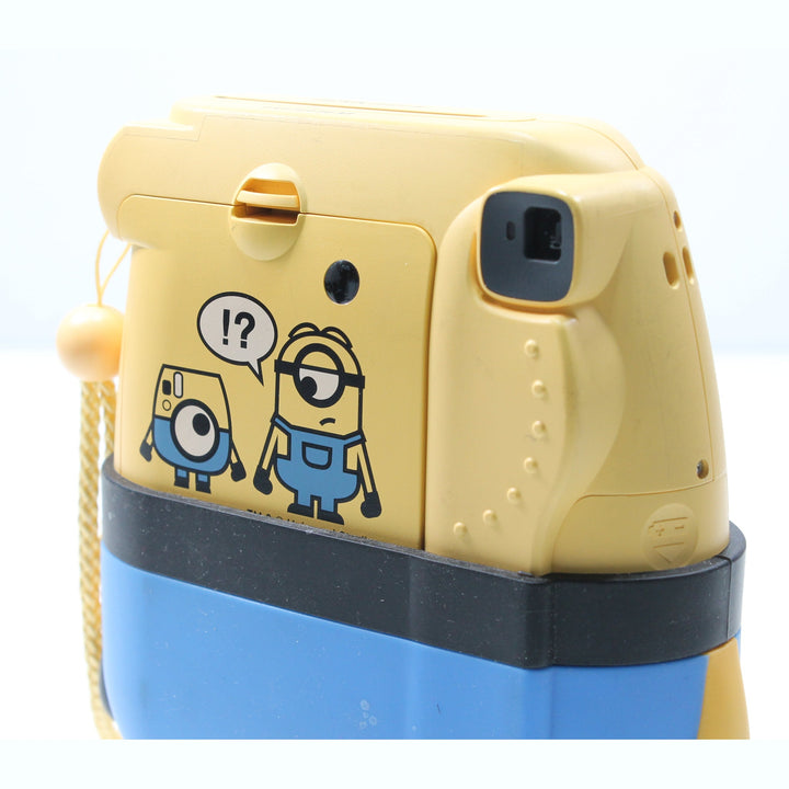 Rear view of Fujifilm Instax Mini 8 Minion Edition featuring cartoon sticker art and film eject slot at ClubCamera.com