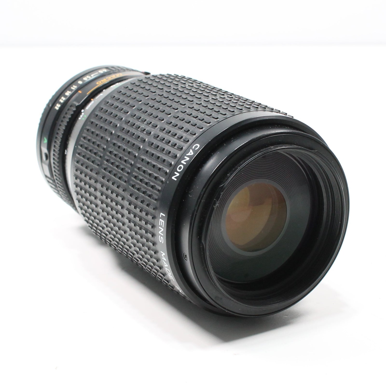 ClubCamera.com Canon FD 75-200mm telephoto zoom lens with white logo and amber multi-coated glass reflections