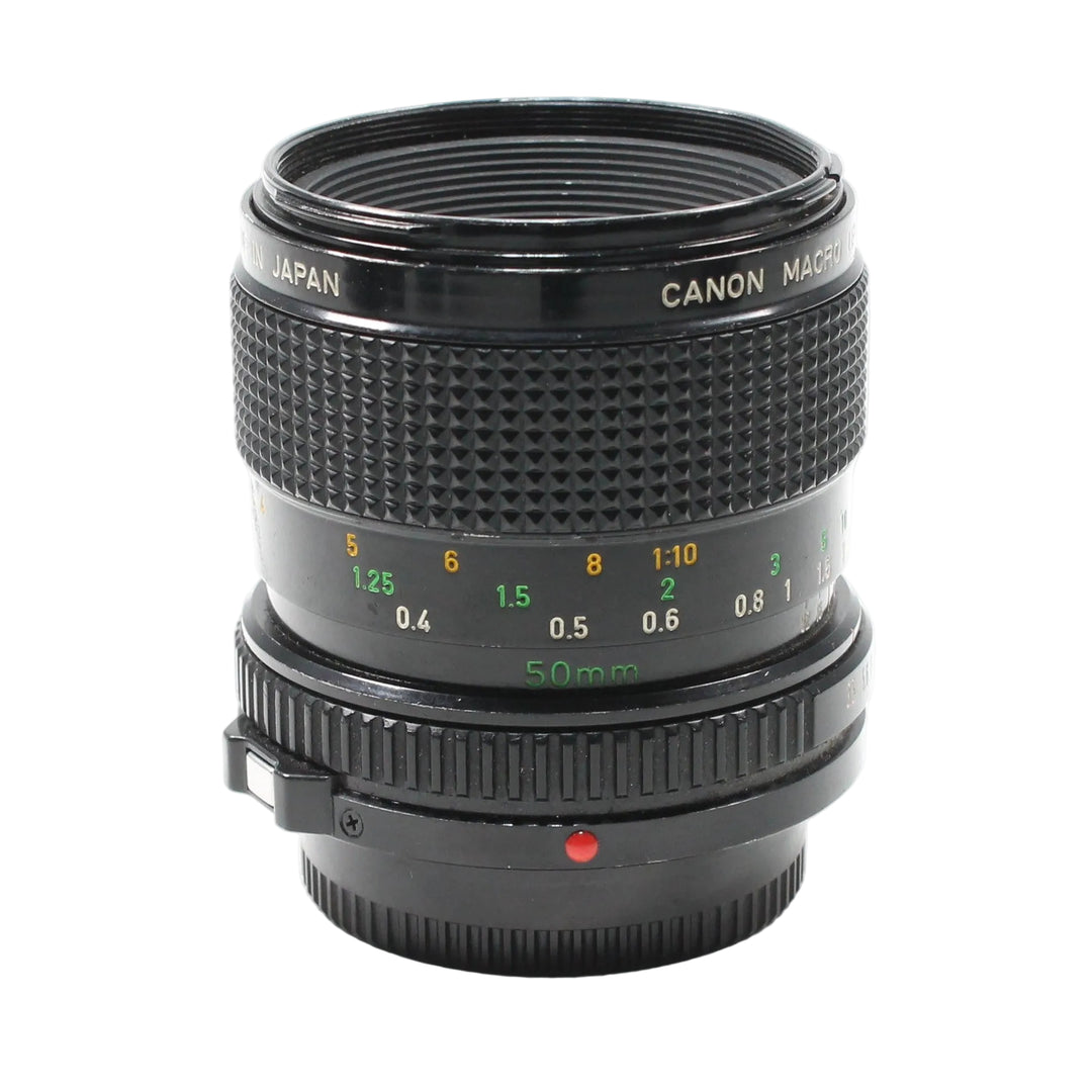 Front view black Canon FD 50mm f/3.5 Macro lens with gold lettering and focus rings at ClubCamera.com