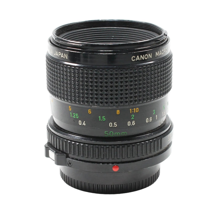 Front view black Canon FD 50mm f/3.5 Macro lens with gold lettering and focus rings at ClubCamera.com