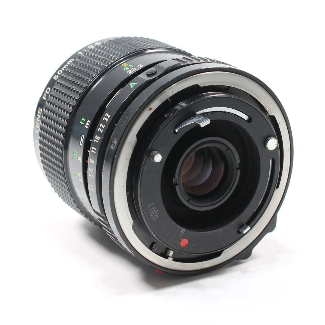 Canon FD 50mm f/3.5 Macro lens rear mount detail with silver ring and red dot at ClubCamera.com