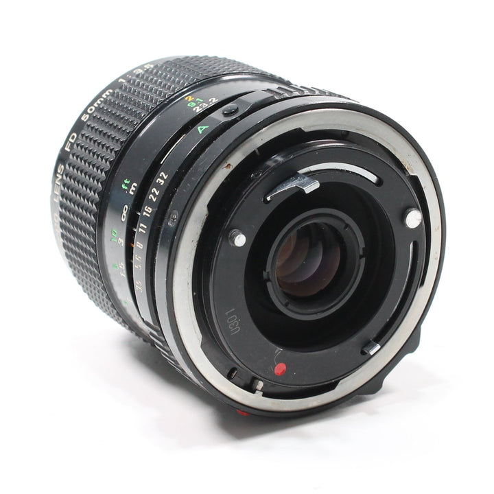 Canon FD 50mm f/3.5 Macro lens rear mount detail with silver ring and red dot at ClubCamera.com