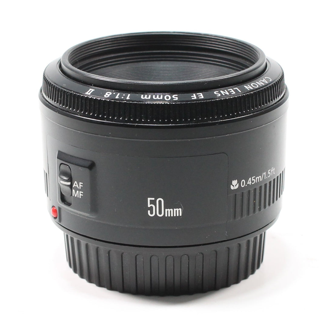 Canon EF 50mm f/1.8 II lens front view with red AF/MF switch and distance scale from ClubCamera.com