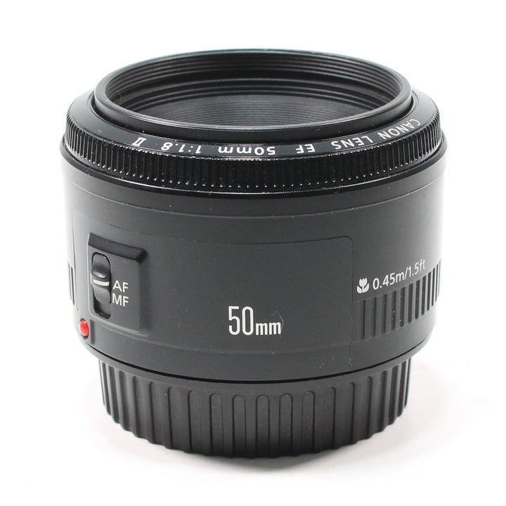 Canon EF 50mm f/1.8 II lens front view with red AF/MF switch and distance scale from ClubCamera.com