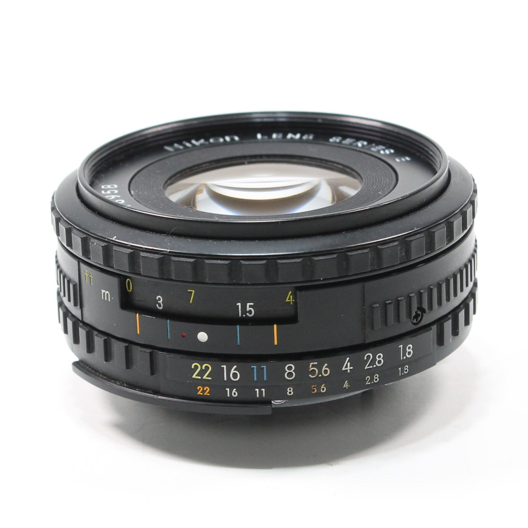 ClubCamera.com Nikon Nikkor 50mm f/1.8 Series E lens side profile with orange distance scale and yellow aperture markings