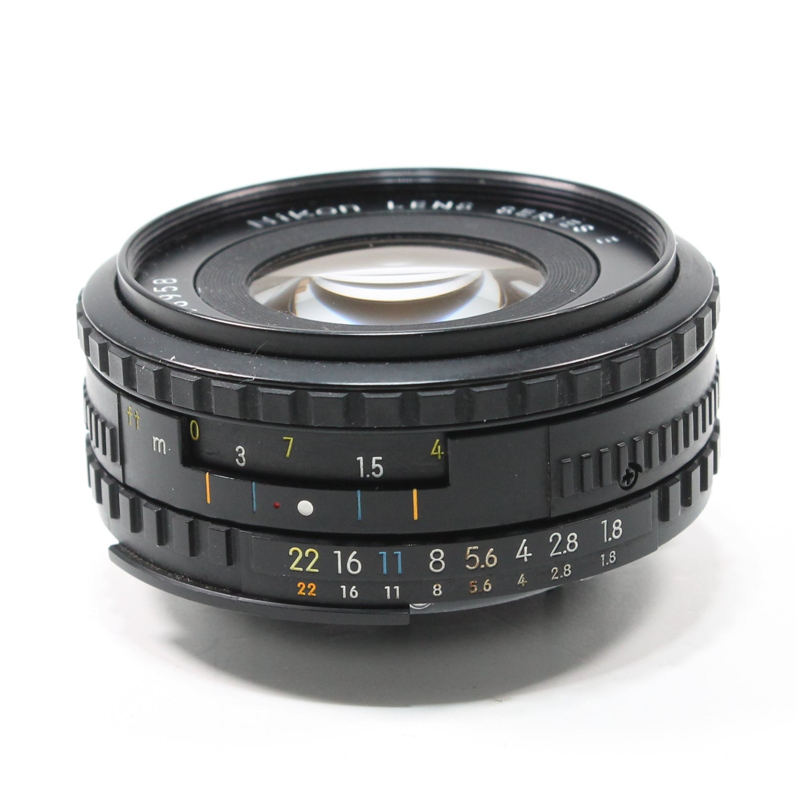 ClubCamera.com Nikon Nikkor 50mm f/1.8 Series E lens side profile with orange distance scale and yellow aperture markings