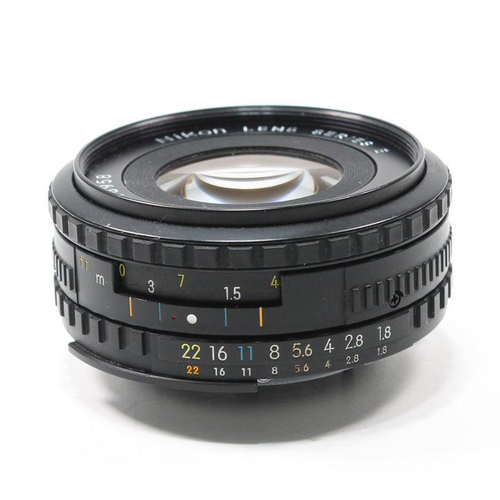 ClubCamera.com Nikon Nikkor 50mm f/1.8 Series E lens side profile with orange distance scale and yellow aperture markings