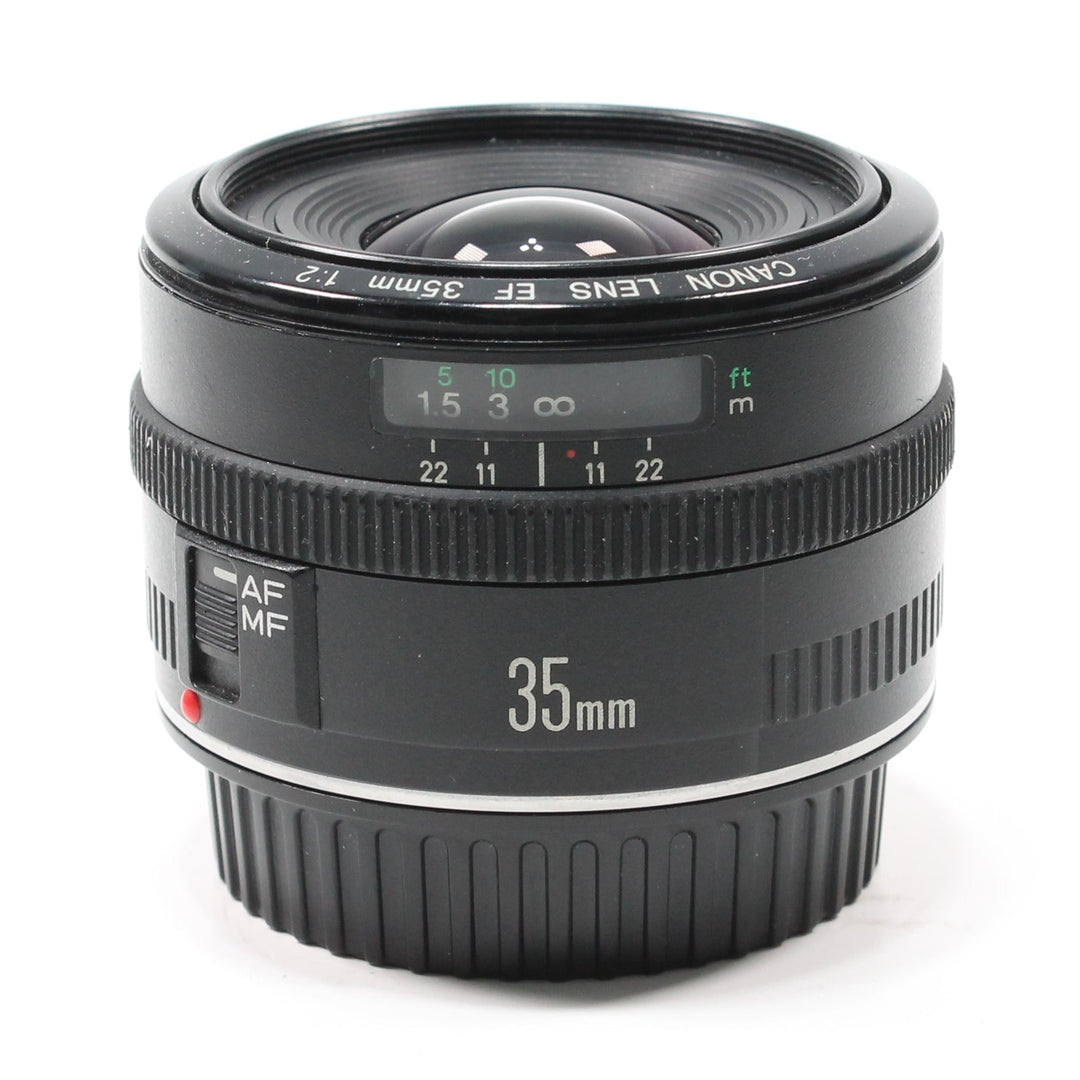 Front profile of Canon EF 35mm f/2 wide-angle lens from ClubCamera.com featuring distance scale window and AF/MF switch