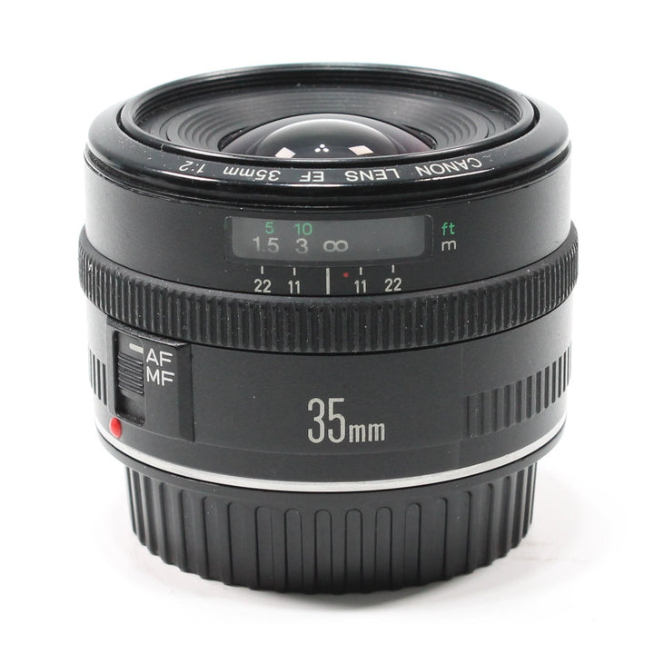 Front profile of Canon EF 35mm f/2 wide-angle lens from ClubCamera.com featuring distance scale window and AF/MF switch