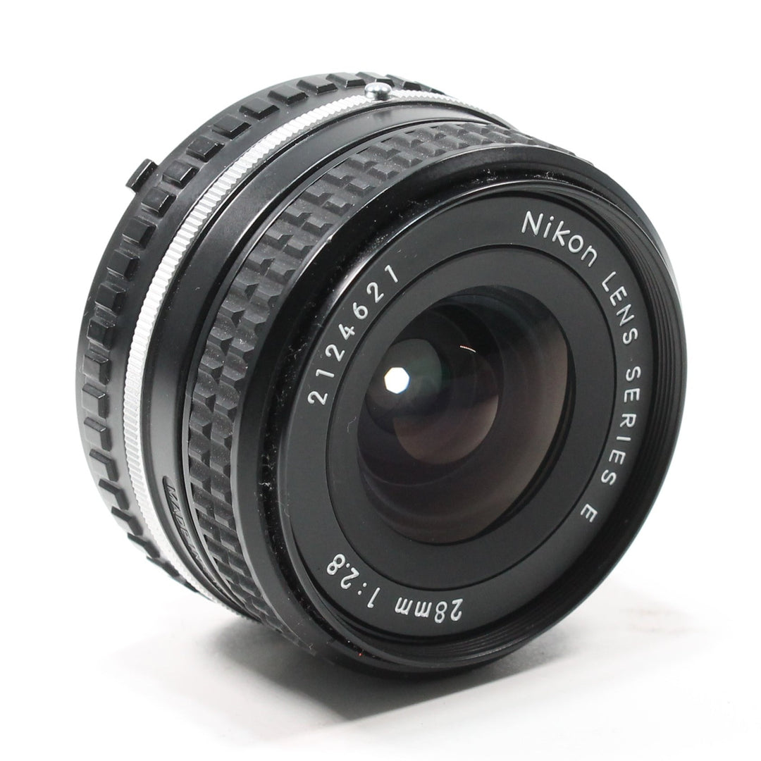 Side view of Nikon 28mm f/2.8 AI-S Series E lens with silver focusing ring and F-mount design at ClubCamera.com
