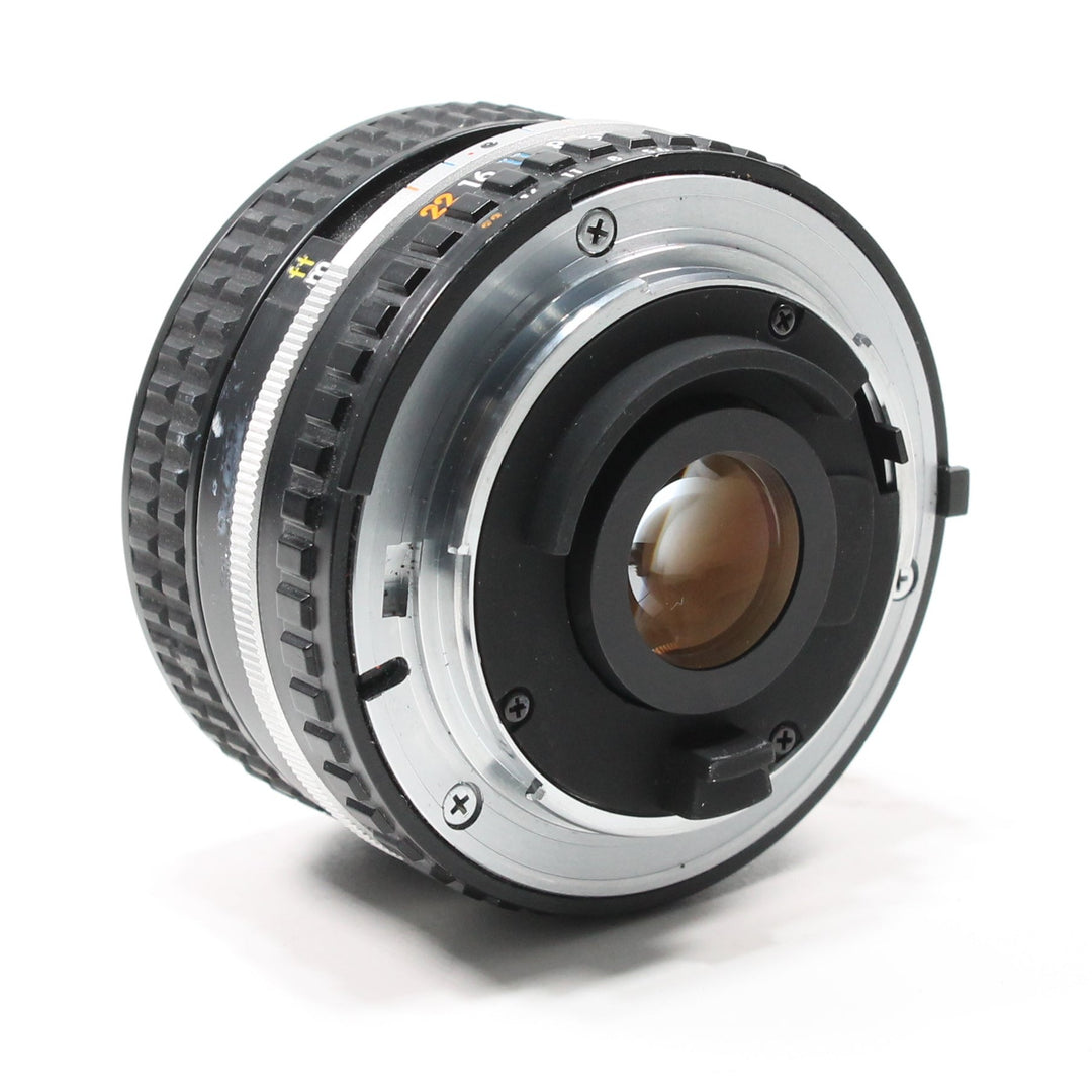 Rear metal mount of black Nikon 28mm f/2.8 AI-S lens with rubber seal and orange markings from ClubCamera.com