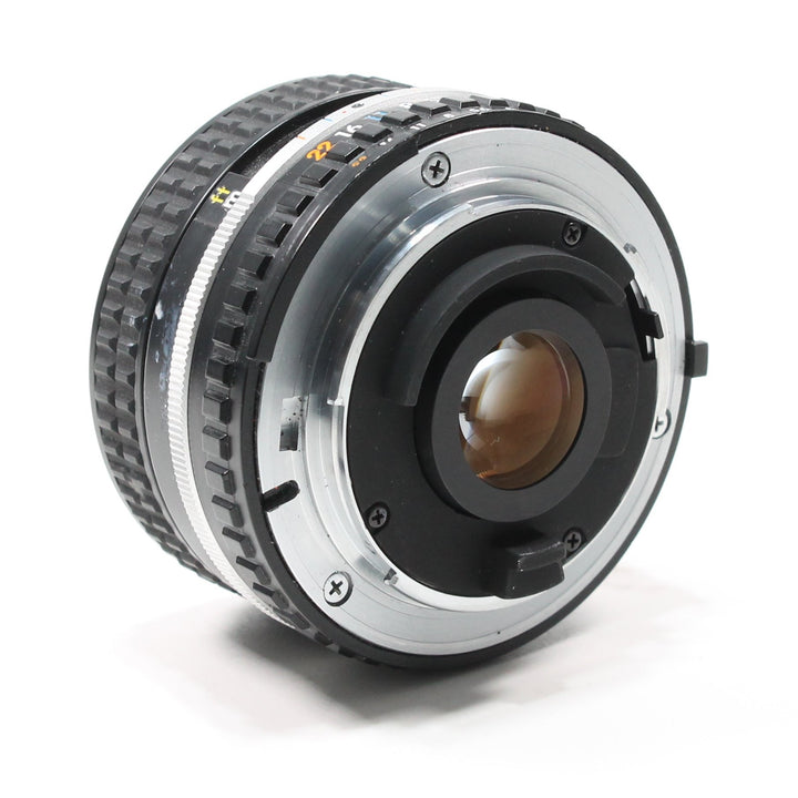 Rear metal mount of black Nikon 28mm f/2.8 AI-S lens with rubber seal and orange markings from ClubCamera.com