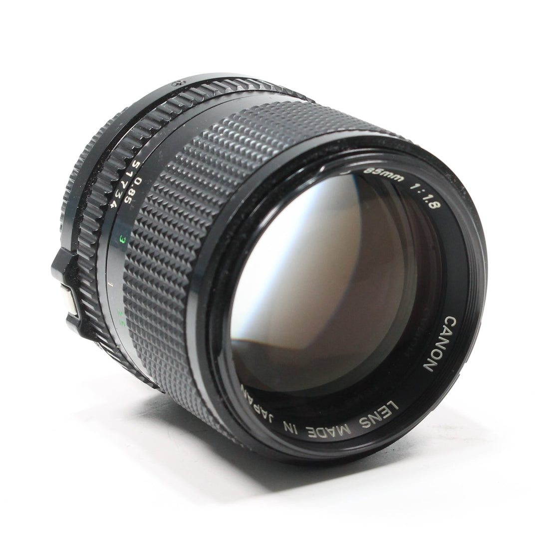 Canon FD 85mm f/1.8 manual focus portrait lens by ClubCamera.com with textured knurled rings and green aperture numerals