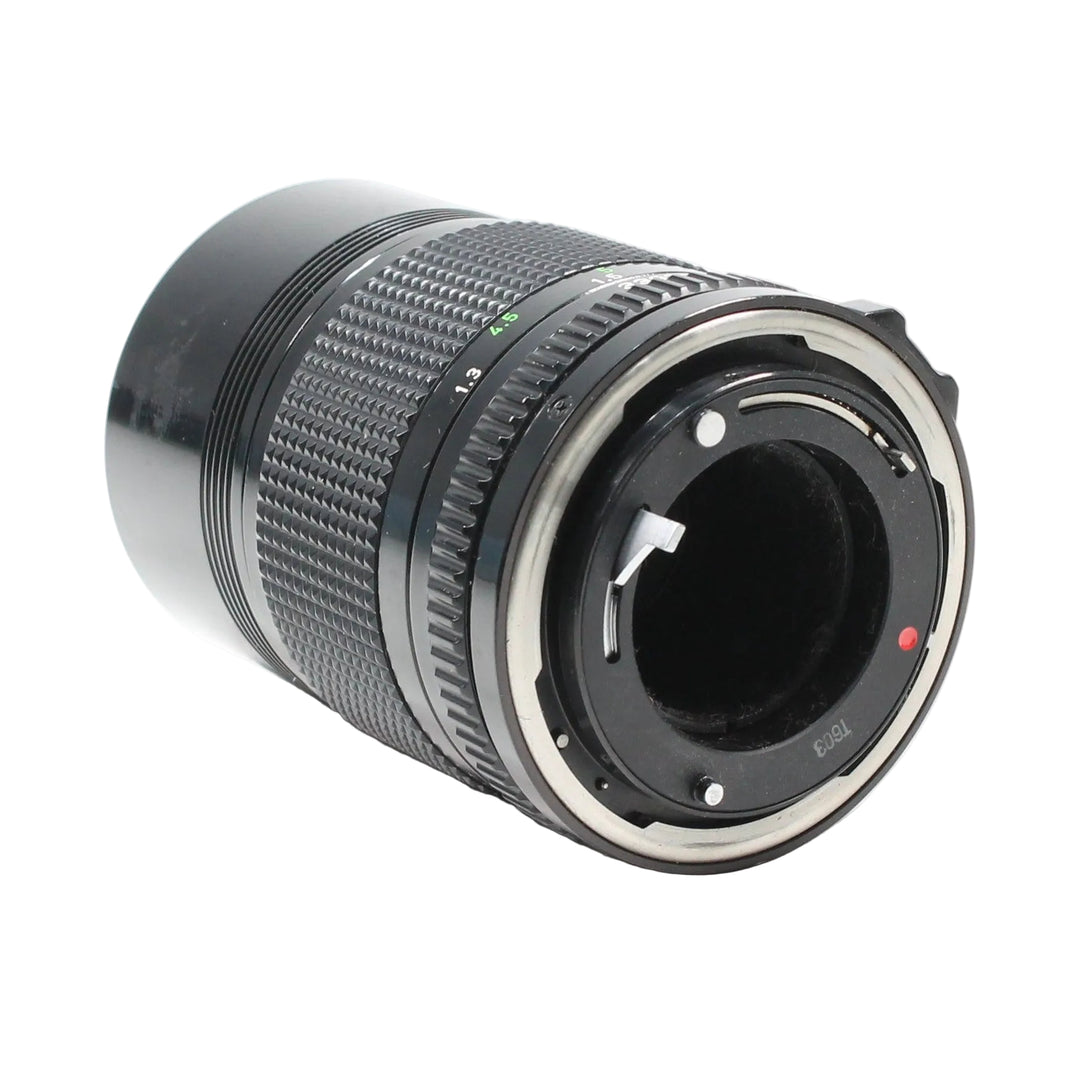 Rear view of Canon FD 135mm f/3.5 lens at ClubCamera.com revealing silver bayonet mount interface aperture lever and internal mechanical details