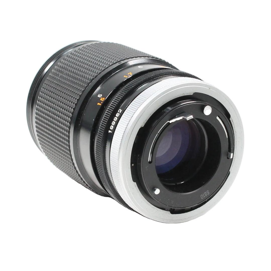 Rear view of Canon FD mount 135mm f/2.5 lens at ClubCamera.com showing silver metal contacts and serial number