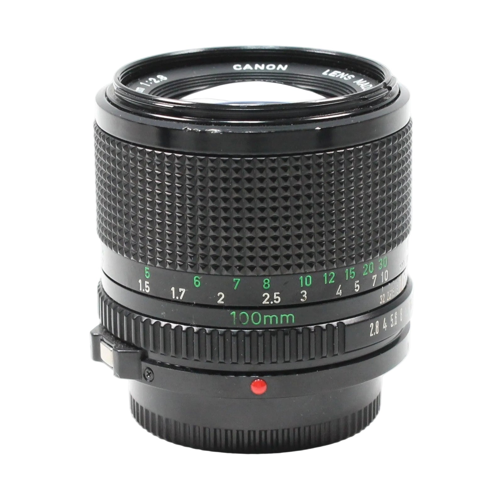 Close-up of Canon FD 100mm f/2.8 prime lens at ClubCamera.com featuring bright green focal length markings and ribbed focus collar