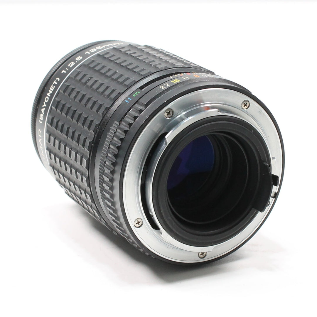 Rear K-mount bayonet interface of Pentax 135mm f/2.8 manual lens with blue coating visible at ClubCamera.com