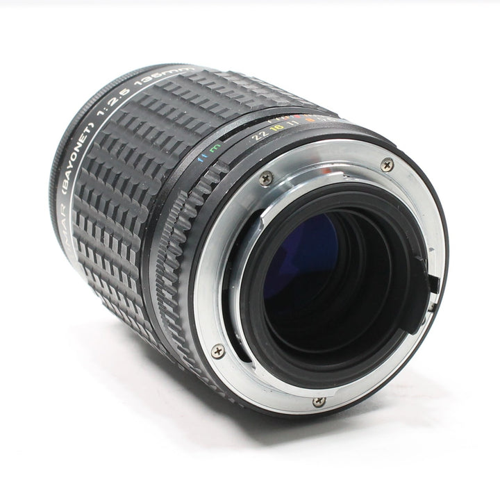 Rear K-mount bayonet interface of Pentax 135mm f/2.8 manual lens with blue coating visible at ClubCamera.com