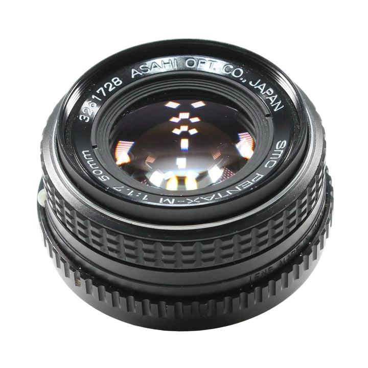 A Pentax Asahi SMC M 50mm f/1.7 lens in black, photographed at an angle on a white background ClubCamera.com