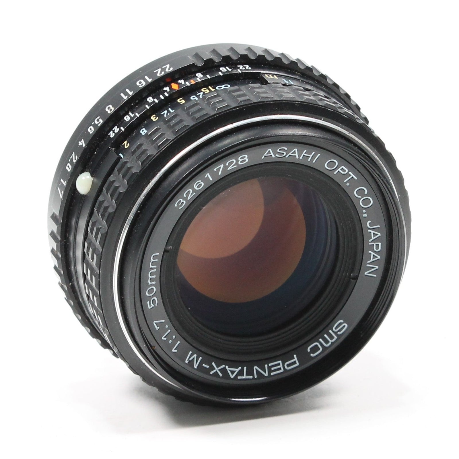 ClubCamera Pentax 50mm f/1.7 prime lens side view with amber glass reflections and white distance markings