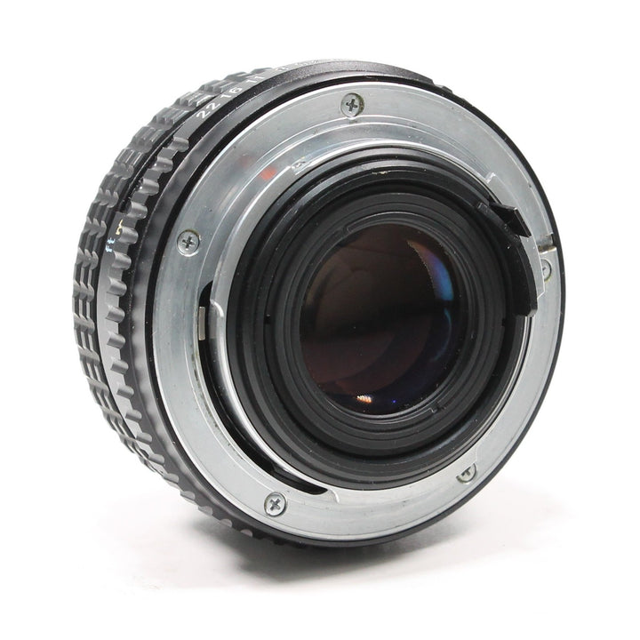 Rear K-mount bayonet interface of black Pentax SMC 50mm f/1.7 lens at ClubCamera with silver metal mount