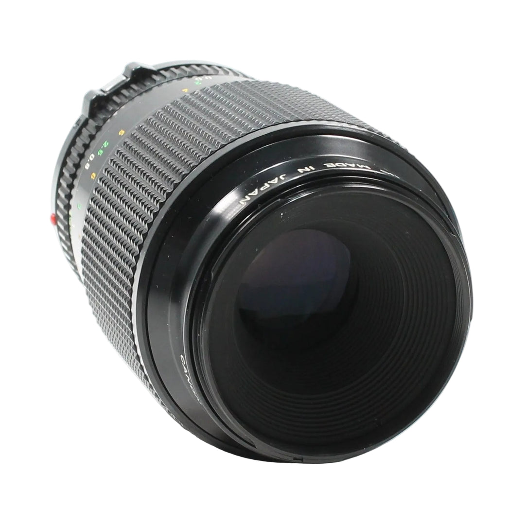 Canon FD 100mm f/4 Macro lens by ClubCamera.com showing ribbed focus ring and MADE IN JAPAN text
