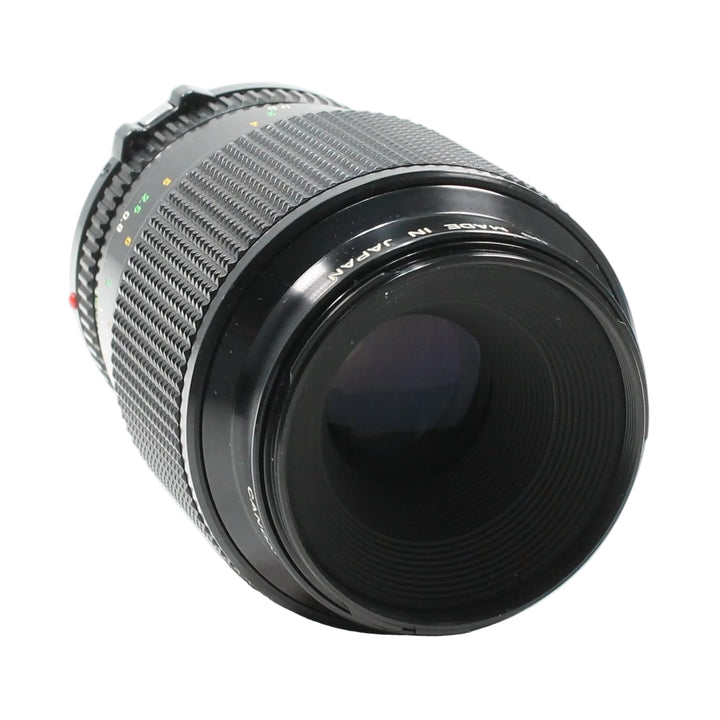 Canon FD 100mm f/4 Macro lens by ClubCamera.com showing ribbed focus ring and MADE IN JAPAN text