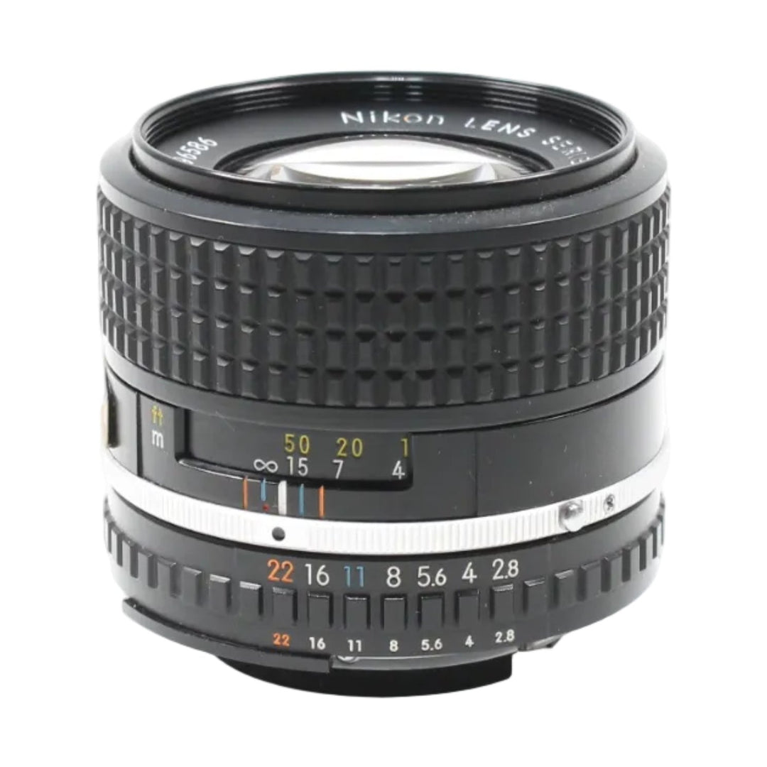 Front shot of black Nikon Series E 100mm f/2.8 manual focus lens showing orange distance scale and aperture ring at ClubCamera.com